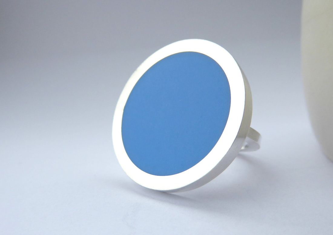 Picture of round statement ring in silver and blue resin