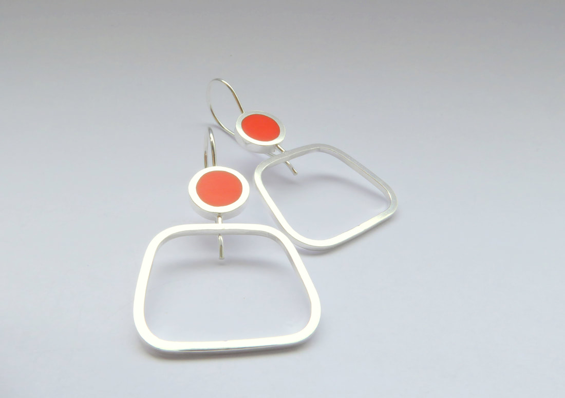 Picture of square silver hoop earrings with orange resin circle 